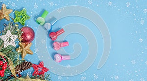 Baner background - Christmas cosmetics sale. Bottles of nail polishes on a blue background with a frame of snowflakes with a copy