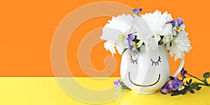 Baner cute mug with a muzzle and a bouquet of flowers on a yellow-orange background.