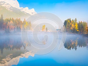 Banff National Park, Alberta, Canada. Fall. Landscape during sunrise. Autumn trees on the river bank. Mountains and forest.