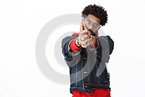 Bang you shot me. Portrait of cool and stylish confident african american handsome guy with beard and afro hairstyle