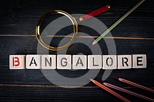 BANGALORE. City name from alphabet blocks on dark wood texture background