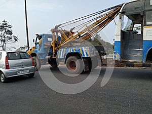 Tow truck delivers the damaged BMTC Bus, Repair and recovery vehicle towing a broken city bus