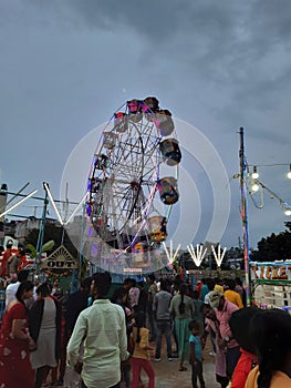 Closeup of beautiful robotic birds and big wheel amusement park near the Kamakshipalya Ground