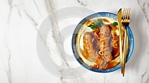 Bangers and mash on a marble table, copy space