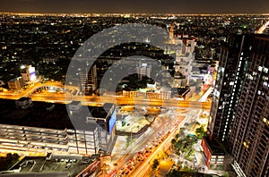 Bangkok city with traffic light and high building at night time