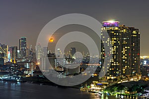 Bangkok cityscape. Bangkok river view with full moon at night