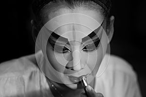 BANGKOK - OCTOBER 16: A Chinese opera actress painting mask on her face before the performance at backstage at major shrine in Ban