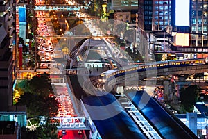 The Bangkok Skytrain passes through Chong Non Si Station a modern office building in Bangkok