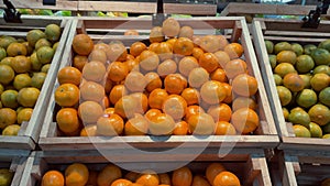 Bangkok, Thailand - 02 Feb 2024. Camera zooms tangerines wooden crate supermarket counter highlighting shopping