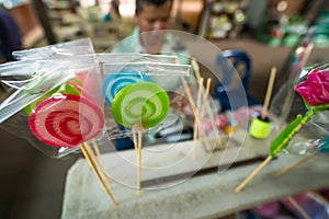 Bangkok, Thailand - April, 16, 2023 : Molding traditional art candy from sugar with food colorant at Taling Chan Floating Markett