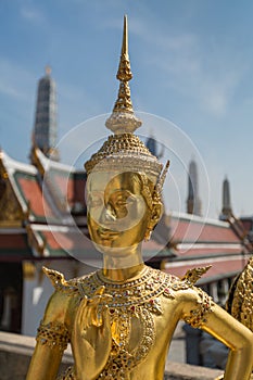 Bangkok, Thailand - April 21, 2015: Golden Kinnari statue outside Buddhist temple in Bangkok's Grand Palace complex, Thailand.