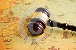 Bangkok, Thailand - December 15, 2021 Judges gavel on ancient vintage world map, international law concept