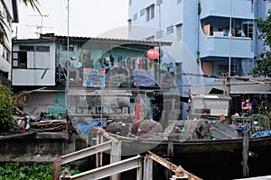 Beggarly dilapidated shack in the Asian metropolis. Modern Asian slums