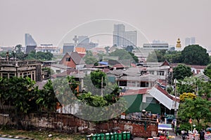 Beggarly shacks of the Asian metropolis. Slums of the capital of Thailand. City landscape