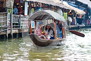 Bangkok, Thailand - Feb 11, 2018: Tourists enjoy traveling by tourist row boat on Lad Mayom canal.