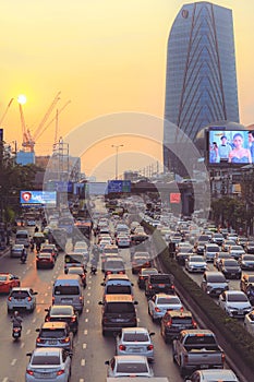 Traffic moves slowly along a busy road in city of Bangkok