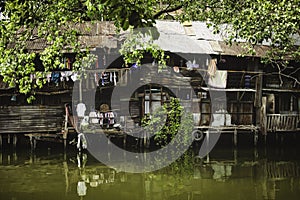 BANGKOK-THAILAND-JAN 18: Riverside slums in Chao Phraya River on January 18 2014 Bangkok Thailand