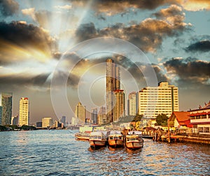 Bangkok, Thailand - January 5, 2020: Chao Phraya River and city skyscrapers from Asiatique Waterfront at sunset