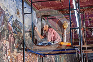 mural art painter renovates the painted wall in the grand Palace, Bangkok