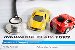 BANGKOK, THAILAND JULY 1, 2022 Stethoscope on Insurance claim accident car form, Car loan, insurance and leasing time concepts