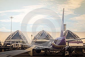 Bangkok, Thailand - June 13, 2017: Terminal building with the airplanes at Suvarnabhumi international airport, Bangkok, Thailand