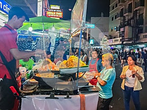 Bangkok, Thailand - March 2, 2017: Street food vendor cooking a