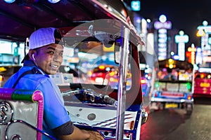 Bangkok, Thailand - March 2019: tuk-tuk taxi driver at China town night market