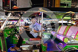 Bangkok, Thailand - March 2019: tuk-tuk taxi driver at China town night market