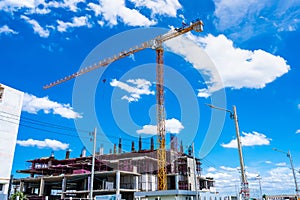 Bangkok, Thailand - May, 22, 2021 :Building crane and building under construction against cloudy sky at Bangkok, Thailand