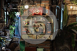 Vintage medicine bottles and Antique collectibles sitting on a store shelf in Cabinet for old wooden storage of medicine to