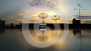 Bangkok, Thailand - Nov 03,2016 : Bangkok cityscape with parabolic satellite dishes at building roof and sunset background