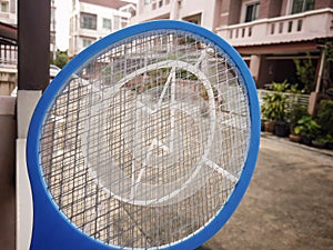 BANGKOK, THAILAND - October 27, 2020: Hand Held Electric Insect Zapper Outdoor at Dusk