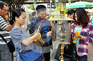 Bangkok, Thailand: People Lighting Incense Sticks