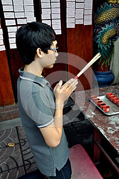 Bangkok, Thailand: Young Man at Prayer