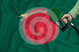 BANGLADESH flag Close-up shot on waving background texture with Fuel pump nozzle in hand. The concept of design solutions. 3d
