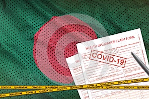 Bangladesh flag and Health insurance claim form with covid-19 stamp. Coronavirus or 2019-nCov virus concept