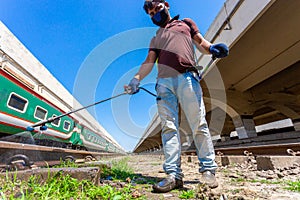An employee sprays disinfectant on a outside of train as a precaution against a new at