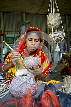 Handicraft maker women are making on a showpiece bird nests using on pineapple fiber at Madhupur,