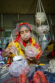 Handicraft maker women are making on a showpiece bird nests using on pineapple fiber at Madhupur,