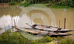 Bangladesh is a riverine country. A calm clear beautiful small river. There are two boats tied up at the wharf