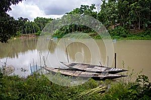 Bangladesh is a riverine country. A quiet beautiful small river. There are two boats tied up at the wharf