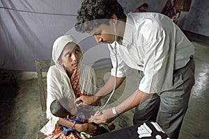 Bangladeshi doctor examining young child