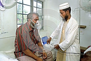 Bangladeshi doctor working in hospital with patient