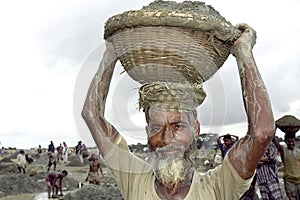 Bangladeshi senior man working in gravel pit