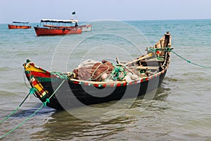 Bangladeshi traditional fishing boat on St. Martin`s Island. Fisherman preparing boat for sailing into the ocean.