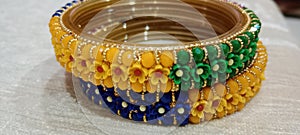 A bangle image with colour combination, yellow, green and blue.