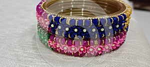 A bangle image with colour combination, yellow, green, pink and blue.