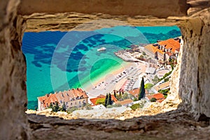 Banje beach in Dubrovnik aerial view through stone window