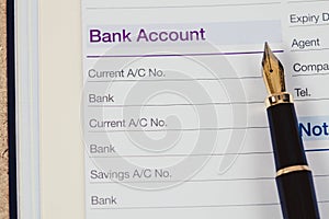 bank account in book note with fountain pen photo