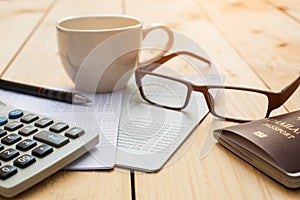 Bank account Pen,glasses ,coffee cup and calculator with passport